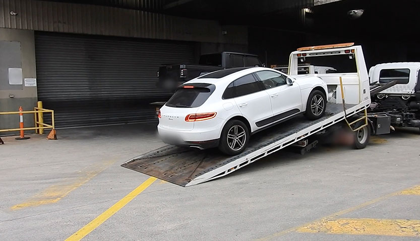 Two men charged after Porsche and luxury items found