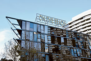 The building at 757 Bourke St, filled with apartments, beauty parlours and restaurants is crowned with an oversized, Vegas style sign that reads “On the beach”, but no one seems to know why!