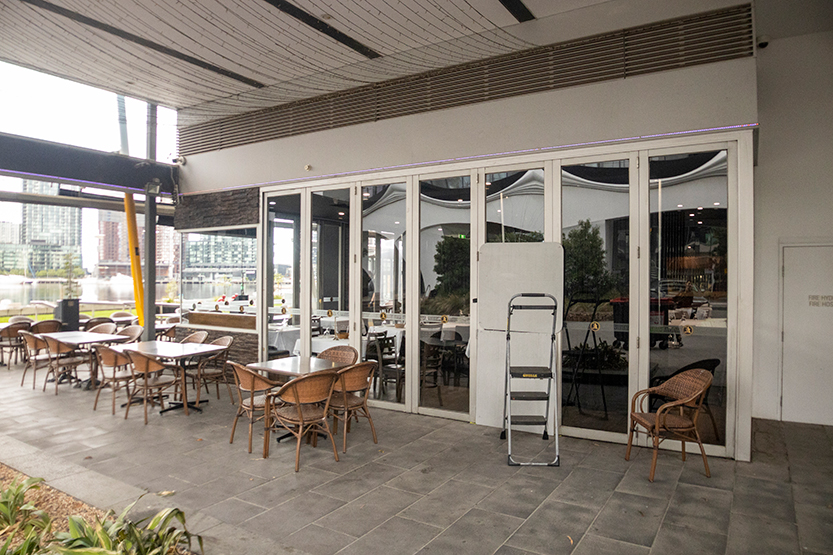 Teen and man charged after second fire attack on Docklands restaurant in three years