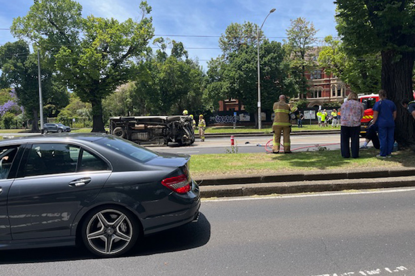 Car flips onto Royal Parade tram tracks after crashing into pole